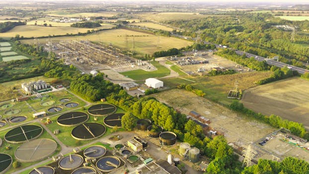 Aerial shot of industrial sites and countryside in Chalton, England during summer.